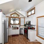 The Magnolia P-518 display model from Platinum Cottages on Display @ RRC Athens. Wrap-around porch, front kitchen park model RV.