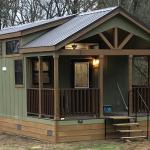 A Premier 577 customer photo showing optional front porch, clerestory windows and more. Also shows stained lap skirting installed by RRC Athens.